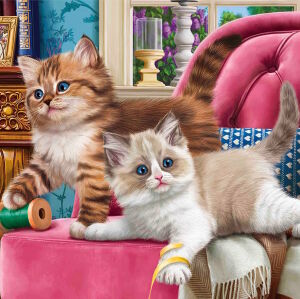 Два котенка на кресле